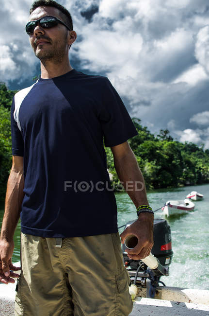 Hombre de pie en barco a motor - foto de stock