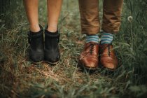 Hipster couple legs on grass — Stock Photo