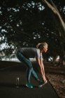 Sporty woman stretching in city park — Stock Photo