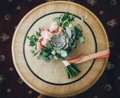 Bridal bouquet of flowers on wooden table — Stock Photo