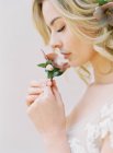 Blonde bride with flowers — Stock Photo