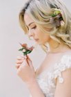 Blonde bride with flowers — Stock Photo