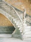 Staircase with female statue on handrails — Stock Photo