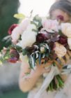 Bride holding fresh bouquet — Stock Photo