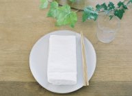 Plate on wooden setting table — Stock Photo