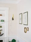 Candlestick and frames hanging on walls — Stock Photo