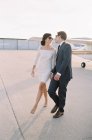 Passionate couple walking at airfield — Stock Photo
