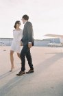 Couple walking at airfield hand in hand — Stock Photo