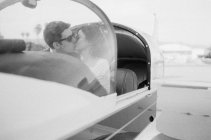 Couple kissing in plane cockpit — Stock Photo
