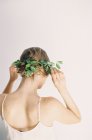 Woman fixing floral hair decoration — Stock Photo