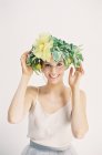 Woman adjusting flower crown — Stock Photo