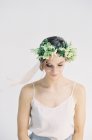 Woman with flower crown looking down — Stock Photo