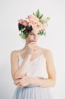 Woman in flower crown biting finger — Stock Photo