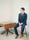 Man in suit sitting on chair — Stock Photo