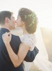 Novio celebración y besar novia - foto de stock