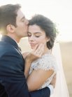 Groom gently kissing bride — Stock Photo