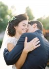 Newly wed couple hugging outdoors — Stock Photo