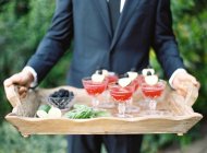 Waiter holding tray with refreshing cocktails — Stock Photo