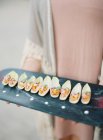 Woman holding tray with canapes — Stock Photo