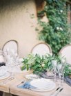 Setting table dexorated with leaves and fruits — Stock Photo