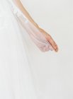 Female hand holding wedding veil — Stock Photo