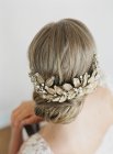 Woman hairdo with flower decoration — Stock Photo