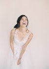 Woman in bridal gown laughing — Stock Photo