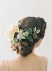 Rose flower and leaves in woman hair — Stock Photo