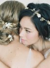 Women in gowns hugging each other — Stock Photo