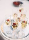 Glasses of champagne with strawberries — Stock Photo