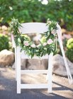 Chair decorated with flowers — Stock Photo