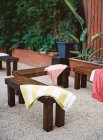 Wooden benches with napkins set outdoor — Stock Photo