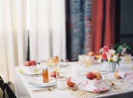 Dinner setting table decorated with fruits — Stock Photo