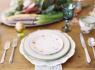 Stacked ceramic plates on setting table — Stock Photo