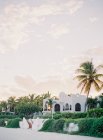 Resort with guest villas and palm trees — Stock Photo
