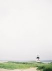 Small lighthouse on island shore — Stock Photo