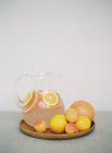 Jar with fresh citrus drink on table — Stock Photo