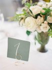 Bouquet in vase on wedding table — Stock Photo