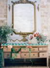 Vintage dresser decorated with flowers — Stock Photo
