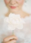 Bride holding fresh flower — Stock Photo
