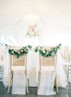 Chairs decorated with fresh cut flowers — Stock Photo