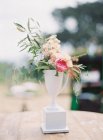 Floral arrangement in white vase — Stock Photo