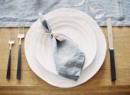 Table napkin on dinner plates — Stock Photo