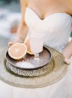 Bride carrying tray with cut grapefruit — Stock Photo