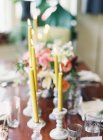 Candles in antique candlesticks — Stock Photo
