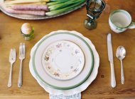 Dinner table with porcelain plates — Stock Photo
