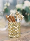Decorative cup with cinnamon sticks — Stock Photo