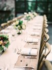Setting table decorated with flowers — Stock Photo