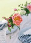 Summer flowers on setting table — Stock Photo