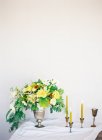 Bouquet of flowers and candles — Stock Photo